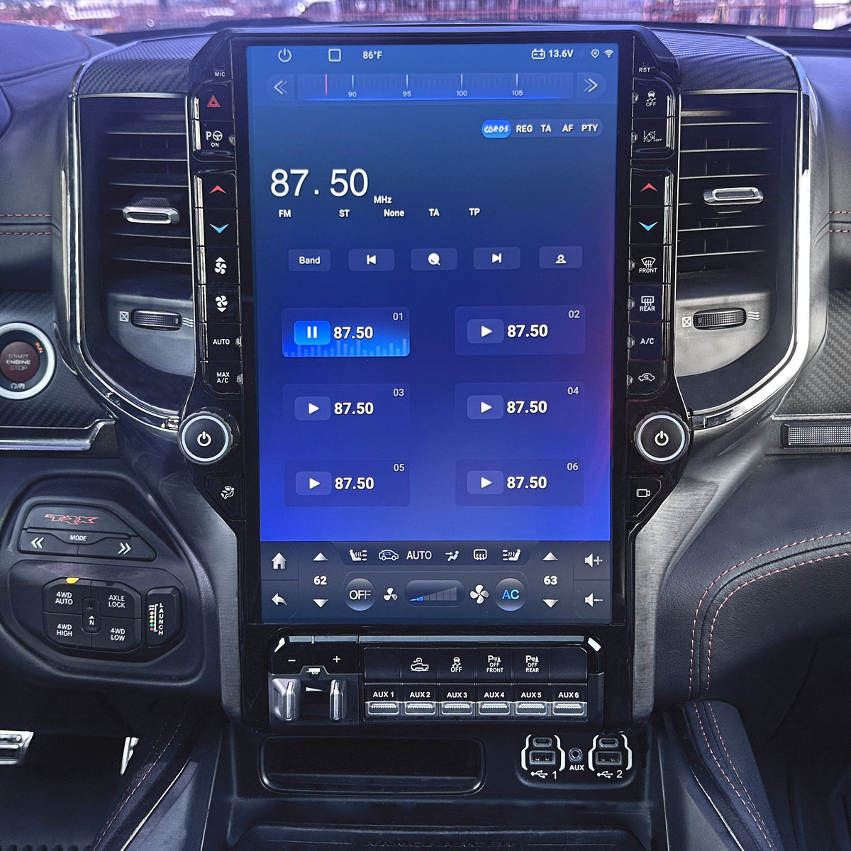 Car interior with a large touchscreen display showing vehicle information.