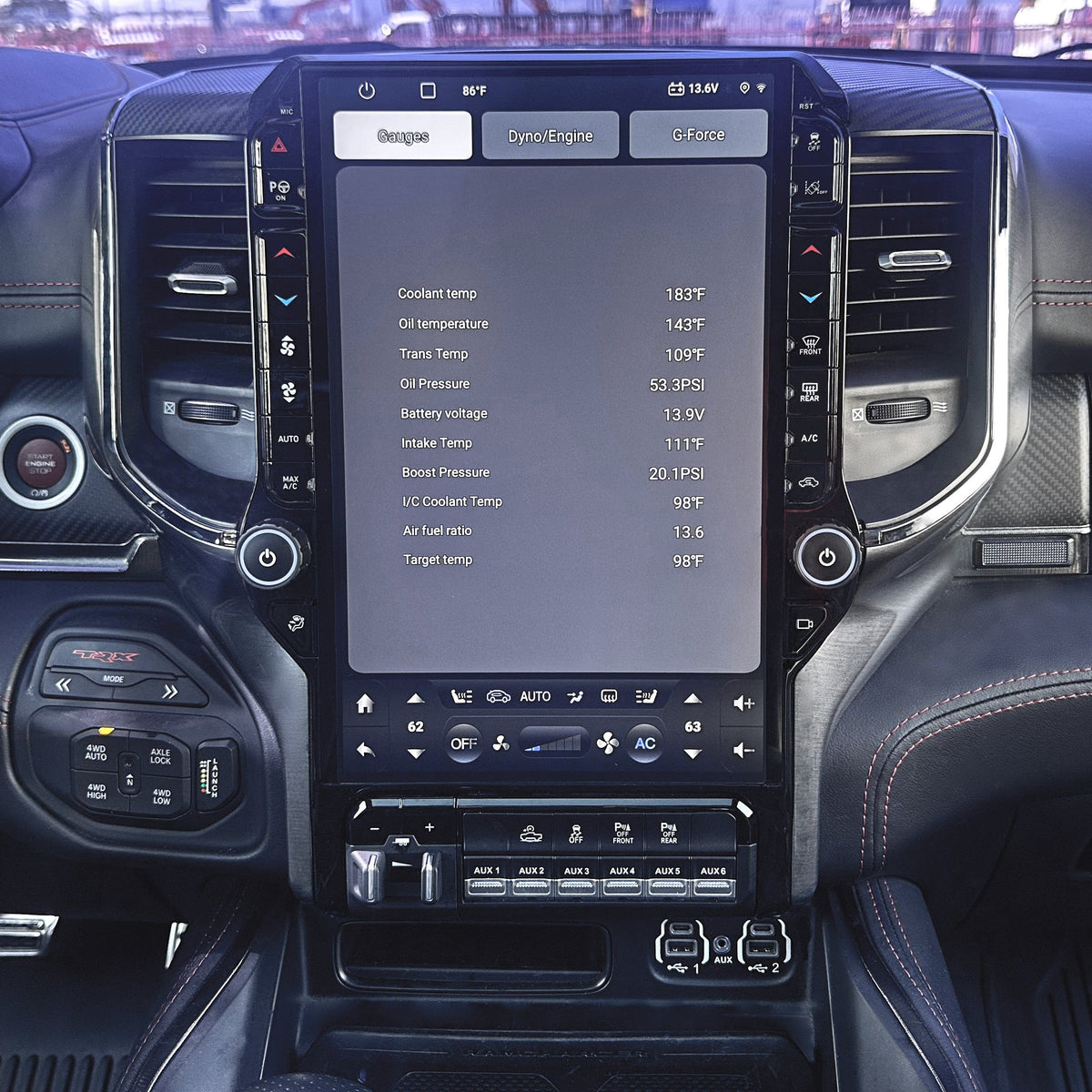 Car interior with a large touchscreen display and dashboard controls.